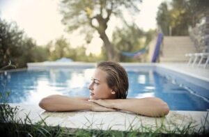 woman, blonde, young, the person, nice, swimming pool, pool, the water, reflections, trees, out, nature, the nature, grass